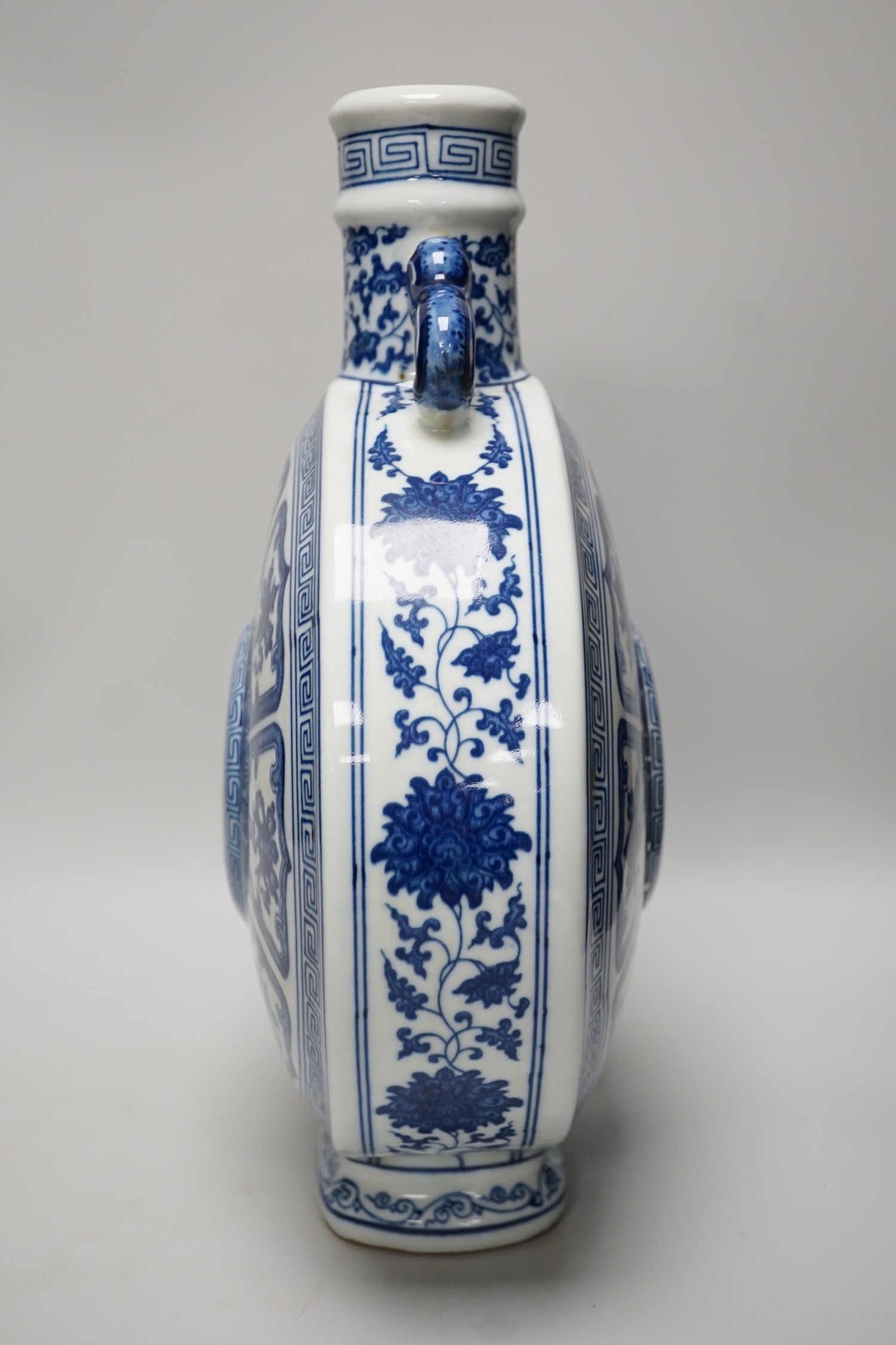 A Chinese blue and white two handled moonflask, together with another Chinese vase and Chinese figure group, tallest 36cm